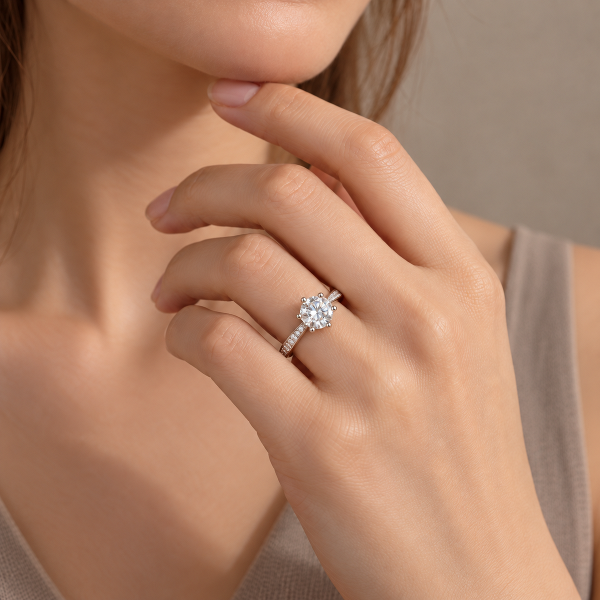 NEARHELD round moissanite ring worn on a hand near the chin