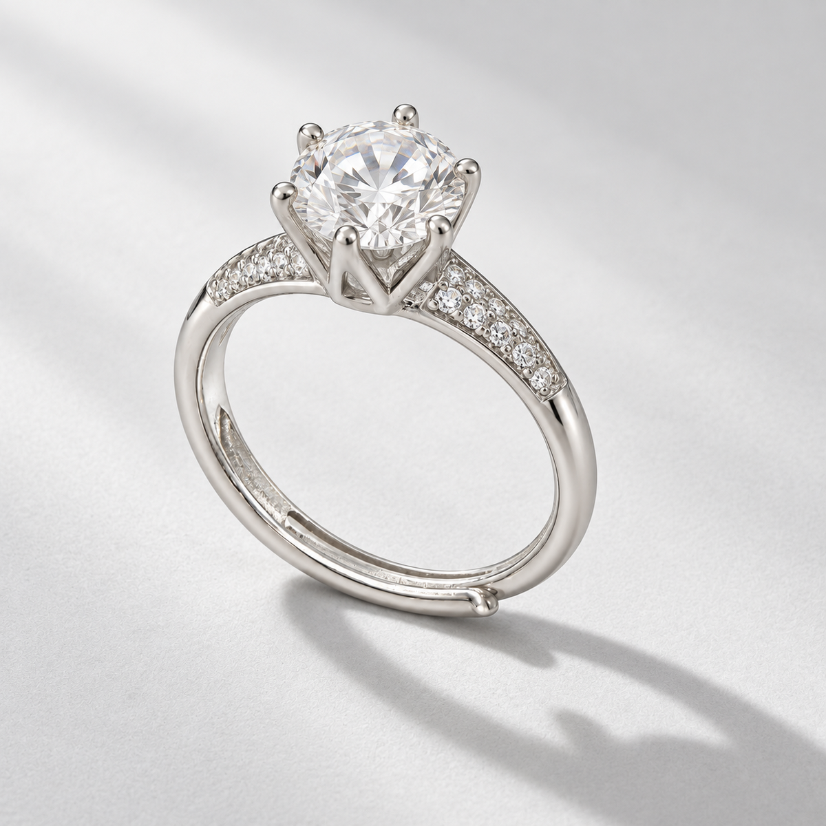 NEARHELD round moissanite crown ring on a pale gray surface in daylight