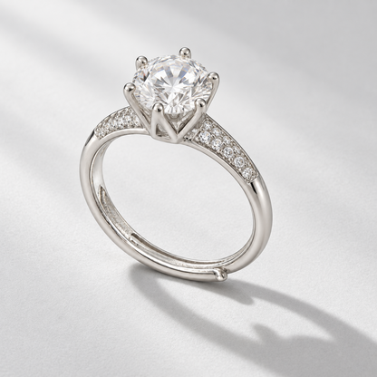 NEARHELD round moissanite crown ring on a pale gray surface in daylight
