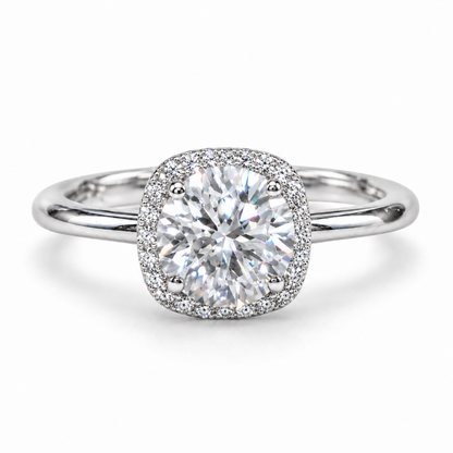 Front view of a round moissanite cushion halo ring with a plain silver band.