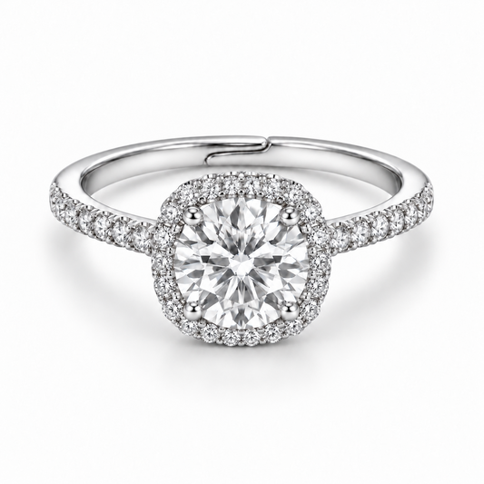Front view of a 1 ct round white moissanite ring with a cushion-shaped halo, four prongs and pavé shoulders in 925 sterling silver.